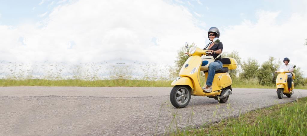 Deux scooters jaunes sur une route de campagne