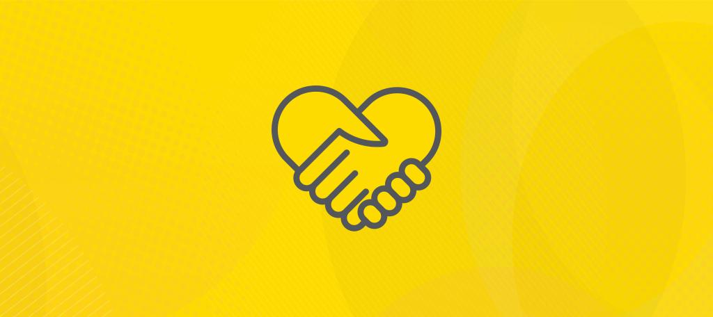Two hands holding each other in a heart shape to symbolize unity.